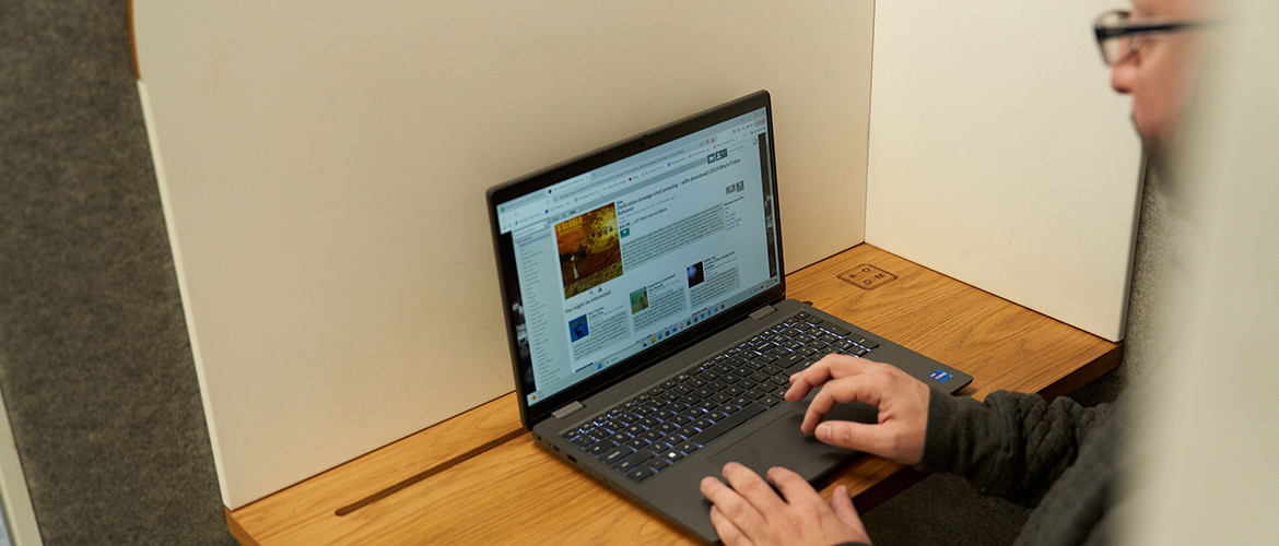 Man with laptop in study room