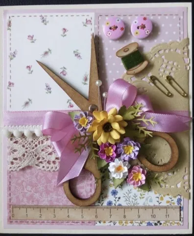 Scrapbooked card with a pink sewing theme.