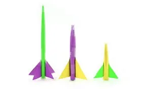 3 paper rockets, lined up from tallest to shortest, made of construction paper in bright green, purple and yellow.