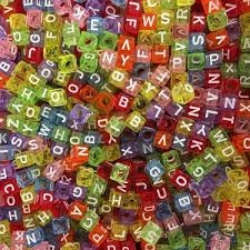 Pony beads in bright translucent multi-colors with white letters on them.